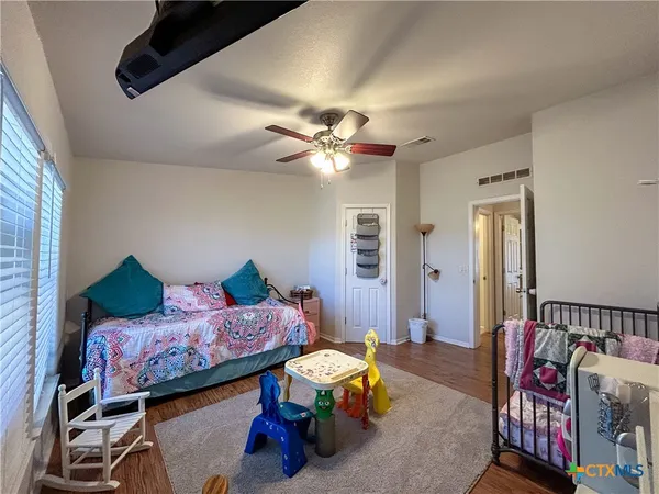 a bed room with furniture and a wooden floor