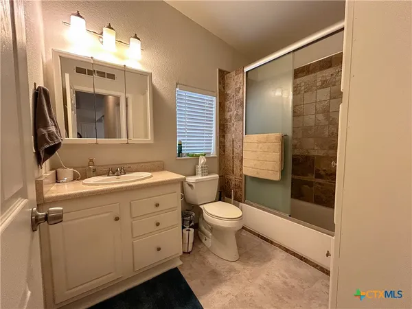 a view of a bathroom with a sink and mirror