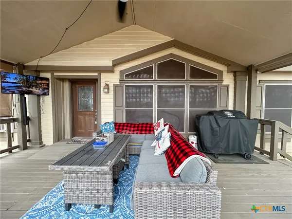a view of deck with couch and chairs