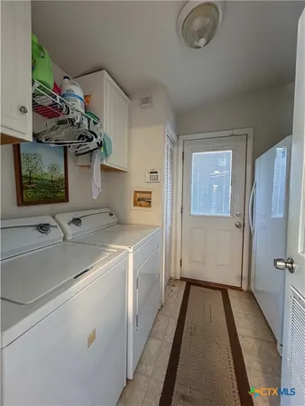 a view of a balcony with chairs and wooden floor