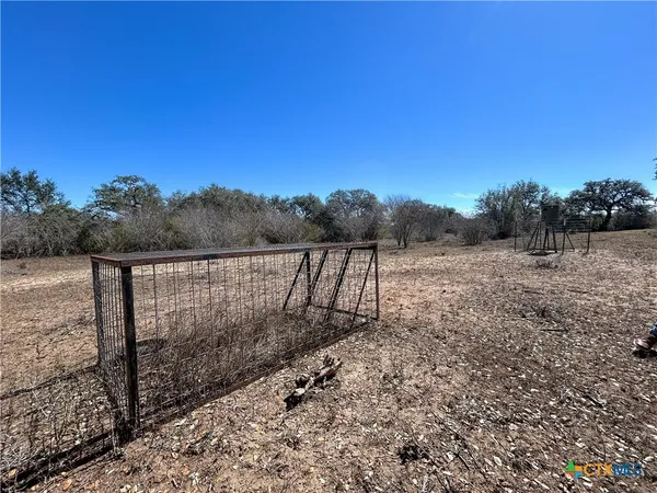 a view of a backyard with wooden fence