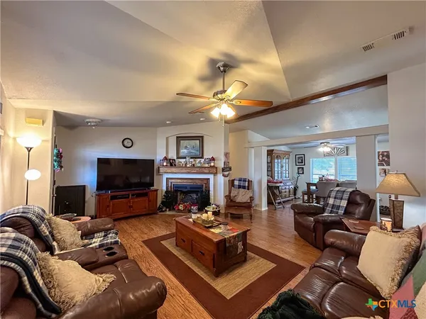 a living room with furniture a fireplace and a flat screen tv