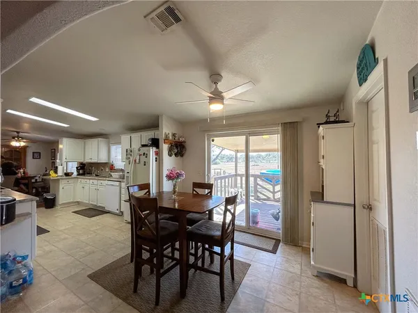 a dining area with furniture and a window