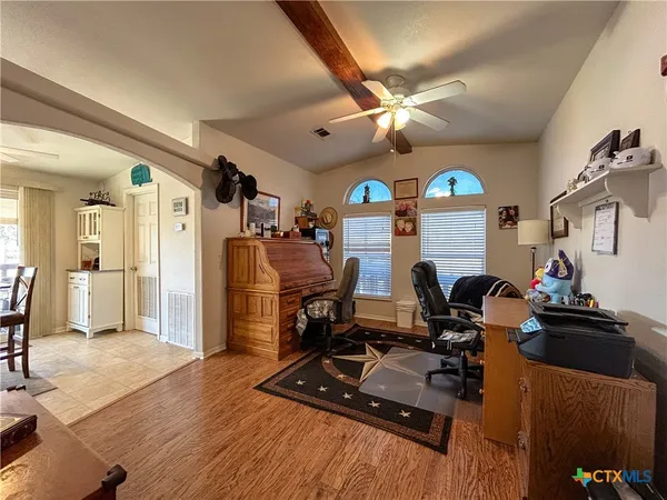 a view of a workspace with furniture and a flat screen tv