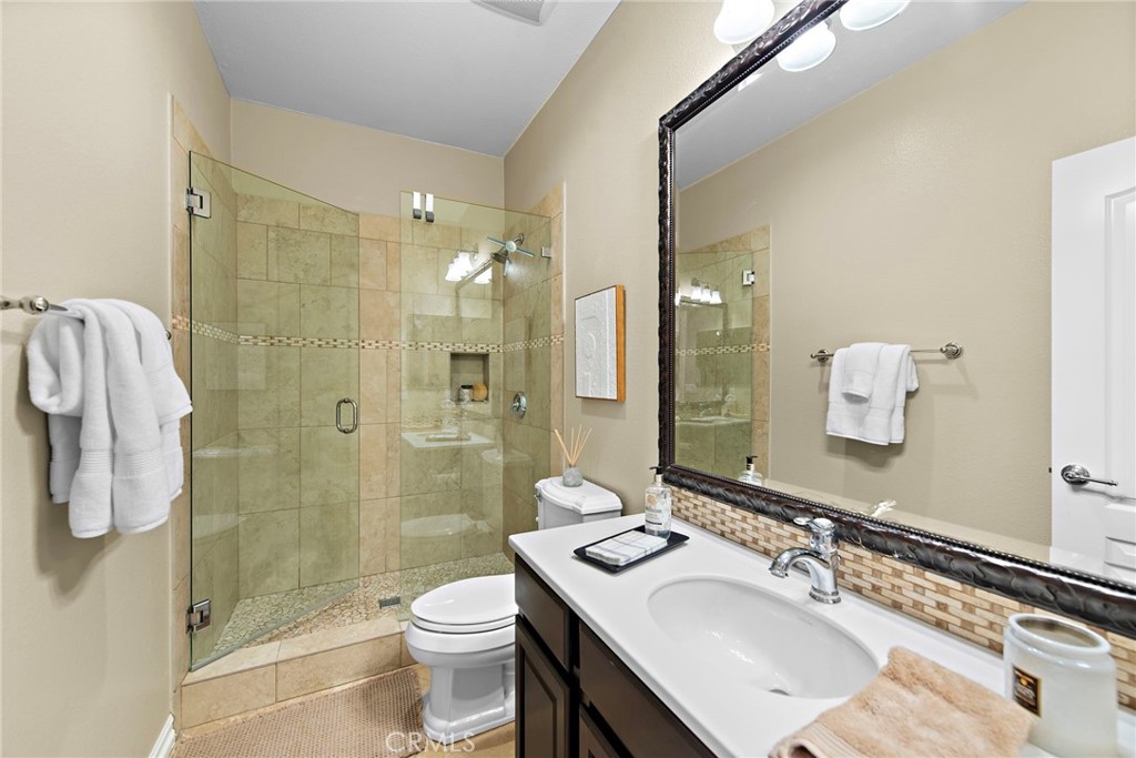 21 Via Cristobal San Clemente, CA 92673 - Photo 15 of 47 a bathroom with a sink vanity granite toilet and shower