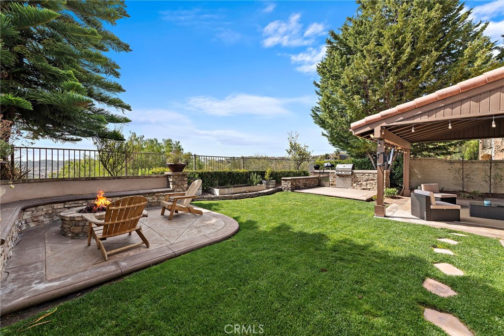 21 Via Cristobal San Clemente, CA 92673 - Photo 31 of 47 a view of a patio with table and chairs potted plants and a palm tree