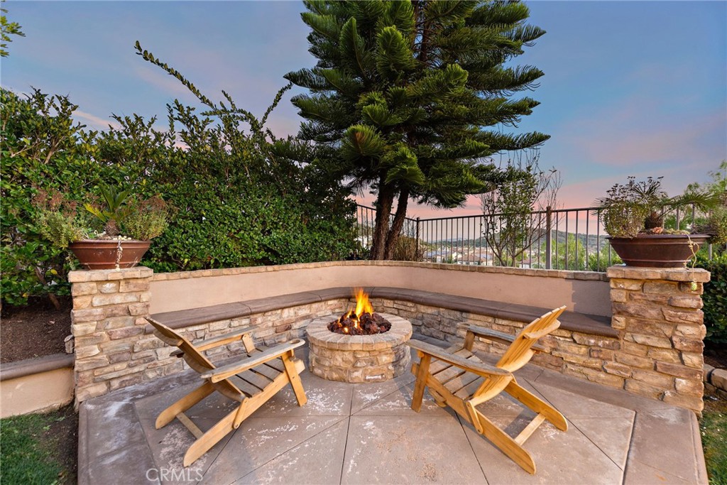 21 Via Cristobal San Clemente, CA 92673 - Photo 39 of 47 a view of a patio with table and chairs potted plants with wooden floor and fence