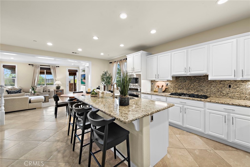 21 Via Cristobal San Clemente, CA 92673 - Photo 9 of 47 a kitchen with stainless steel appliances granite countertop a table and chairs