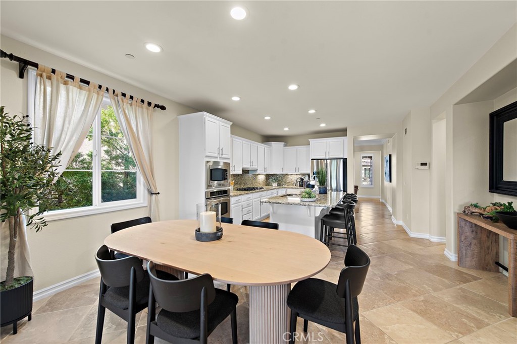 21 Via Cristobal San Clemente, CA 92673 - Photo 10 of 47 a kitchen with stainless steel appliances a dining table chairs and a refrigerator