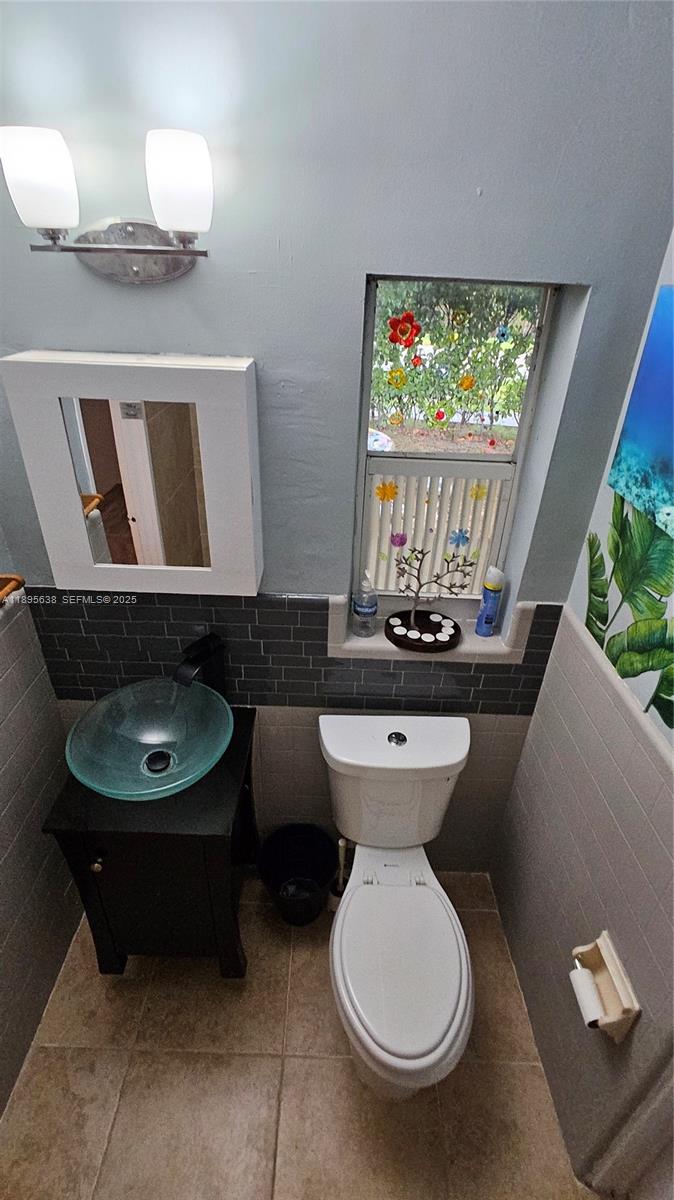 4201 Southwest 60th Place, Unit 2 South Miami, FL 33155 - Photo 13 of 14 a bathroom with a toilet a sink and a mirror