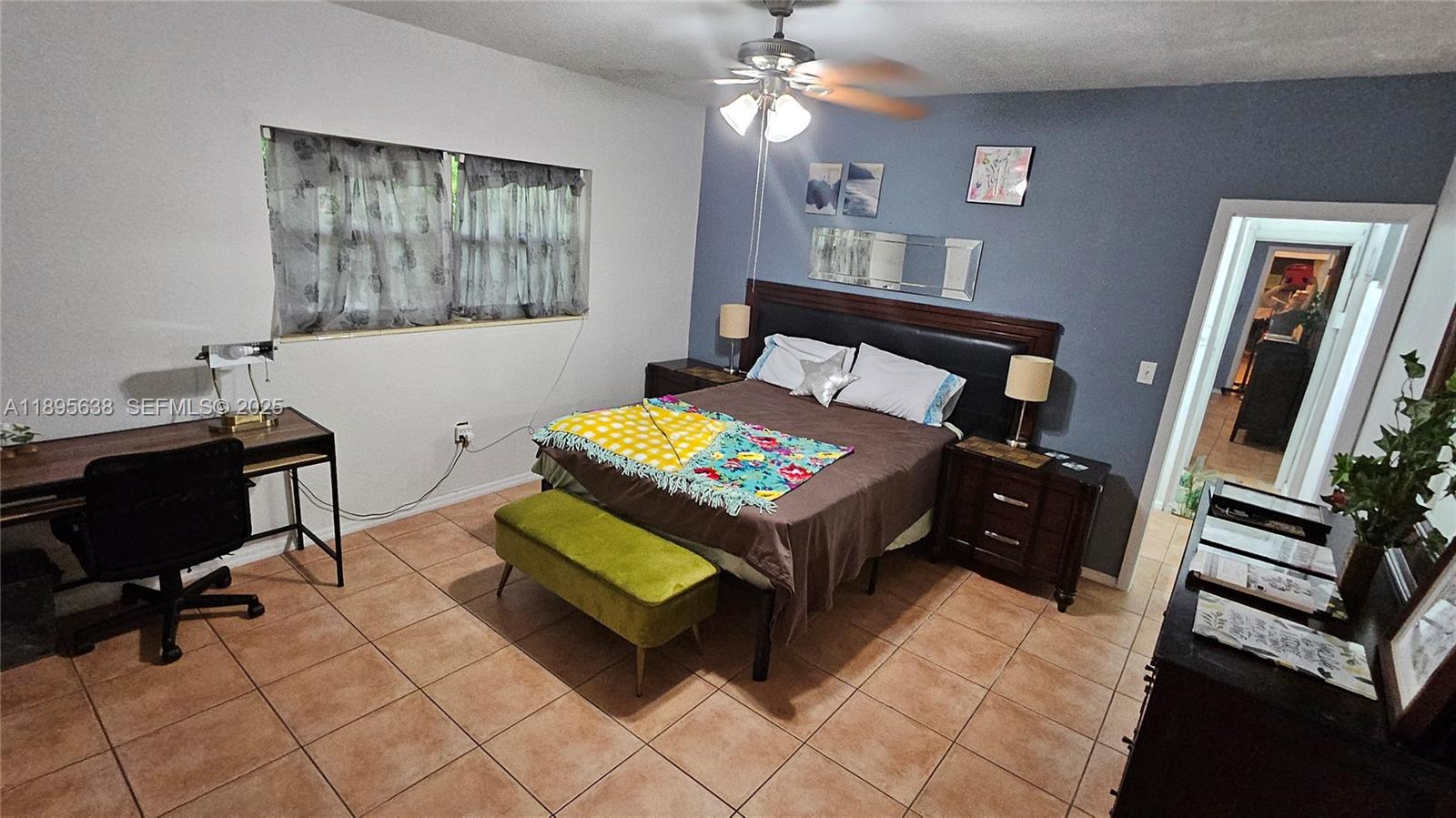 4201 Southwest 60th Place, Unit 2 South Miami, FL 33155 - Photo 10 of 14 a bedroom with a bed and a mirror