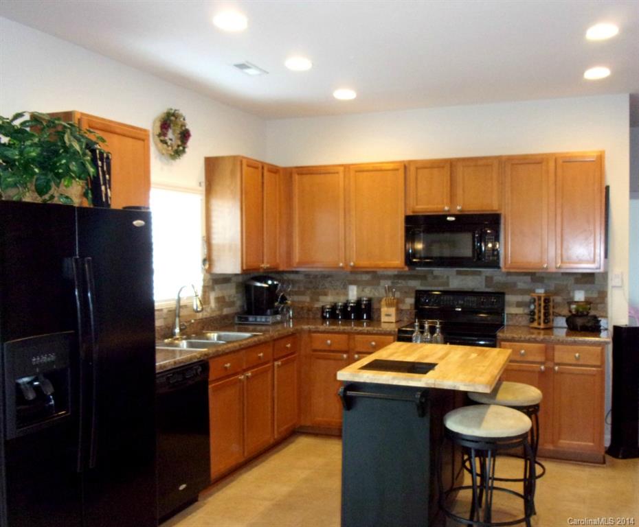 1019 Green Terra Road Indian Trail, NC 28079 - Photo 3 of 20 a kitchen with a sink a counter top space appliances and cabinets