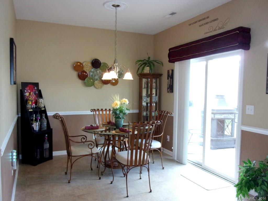 1019 Green Terra Road Indian Trail, NC 28079 - Photo 4 of 20 a view of a dining room with furniture and chandelier