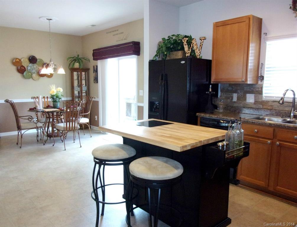 1019 Green Terra Road Indian Trail, NC 28079 - Photo 5 of 20 a dining room with granite countertop a table chairs and a dining table