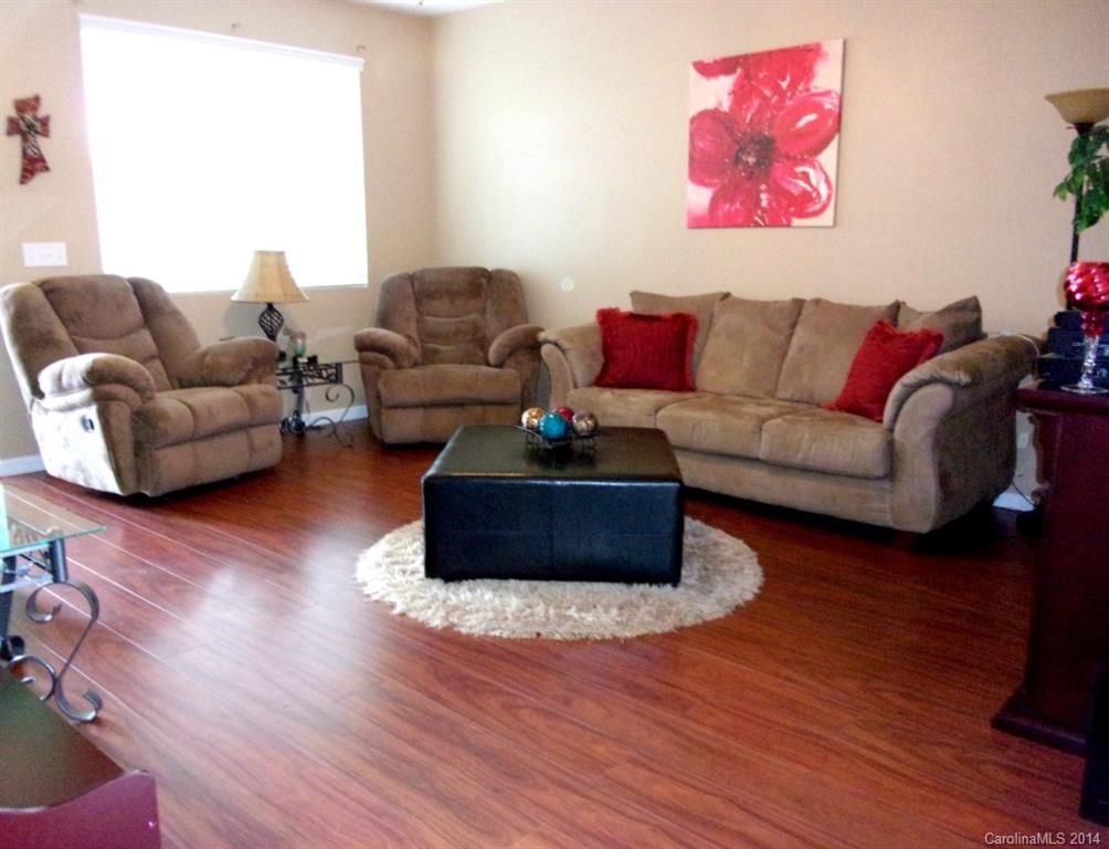 1019 Green Terra Road Indian Trail, NC 28079 - Photo 6 of 20 a living room with furniture a wooden floor and a potted plant