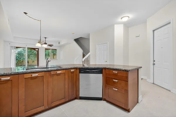 a kitchen with stainless steel appliances granite countertop a stove a sink and a wooden floors