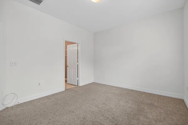 a view of an empty room and a window