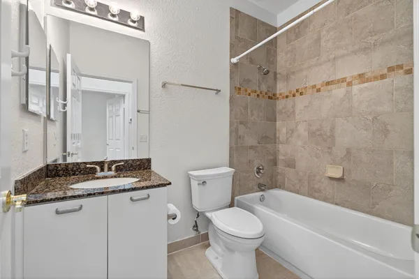 an empty room with a fan & a window