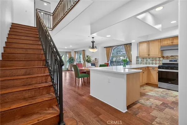 a kitchen with stainless steel appliances a sink stove and cabinets
