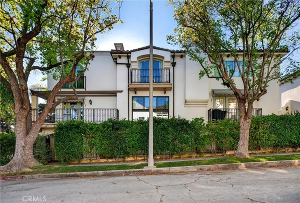 a front view of house with yard outdoor seating and potted plants