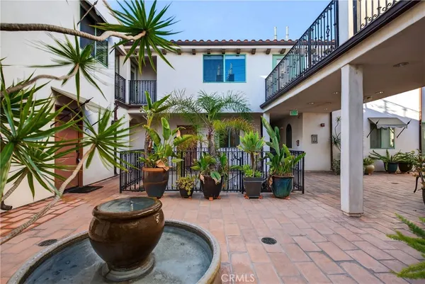 a house with potted plants in front of it