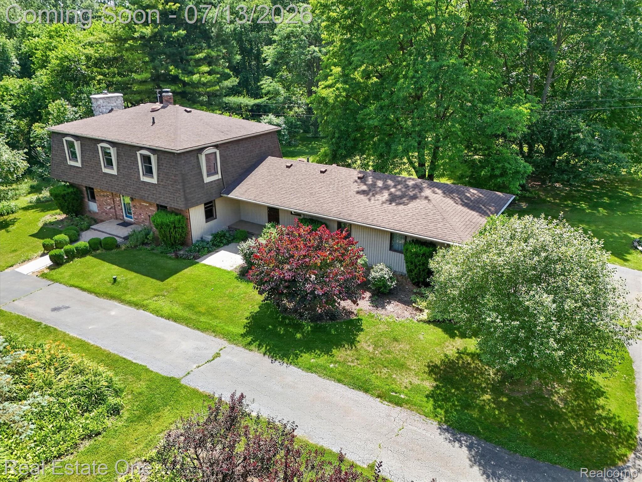 6039 Fish Lake Road Holly, MI 48442 - Photo 55 of 70 Unique two-story residence featuring a prominent stone chimney and a varied roofline