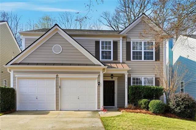 a view of a house with a yard and garage