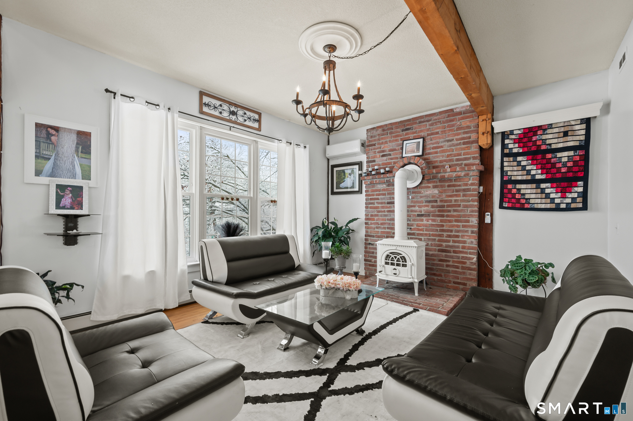 278 Thompsonville Road Suffield, CT 06078 - Photo 12 of 38 a living room with furniture a chandelier and a fireplace