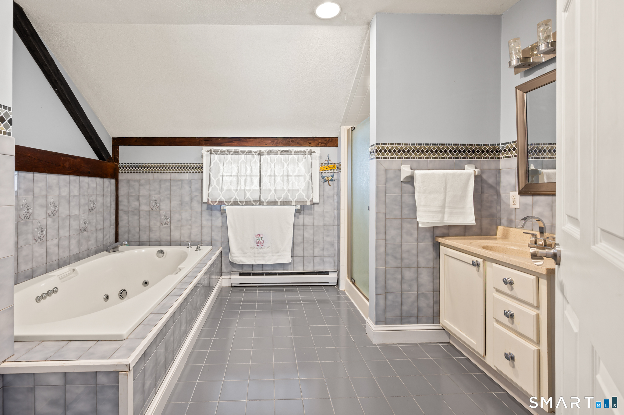 278 Thompsonville Road Suffield, CT 06078 - Photo 26 of 38 a bathroom with a bathtub sink and mirror