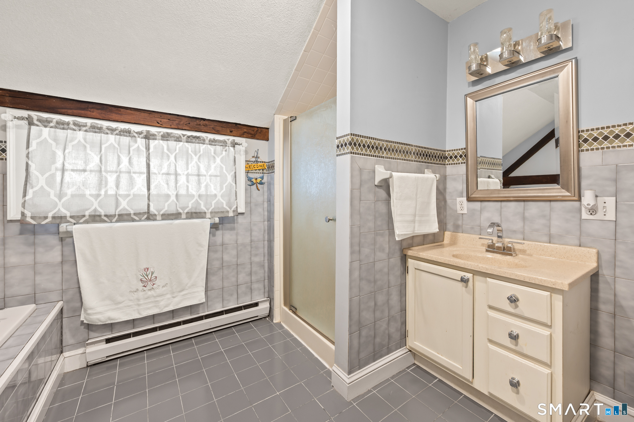 278 Thompsonville Road Suffield, CT 06078 - Photo 27 of 38 a bathroom with a granite countertop sink a mirror and a shower