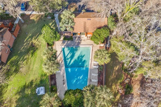 an aerial view of a house with a yard