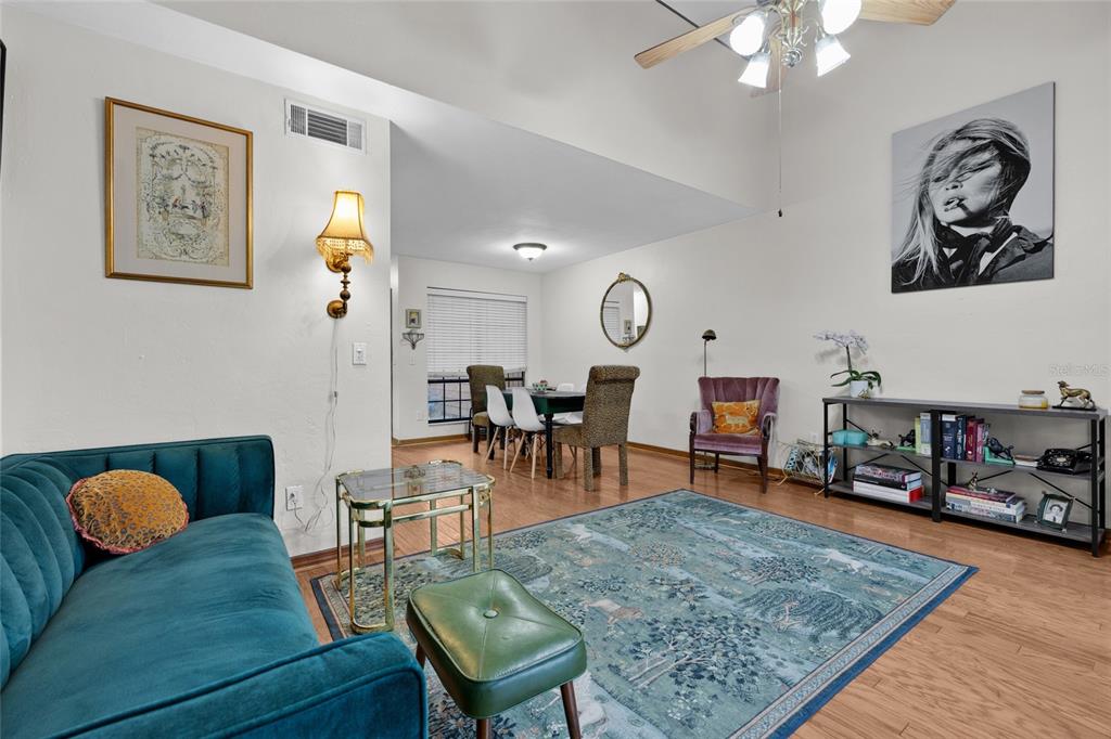 900 Southwest 62nd Boulevard, Unit L79 Gainesville, FL 32607 - Photo 21 of 24 a living room with furniture and wooden floor