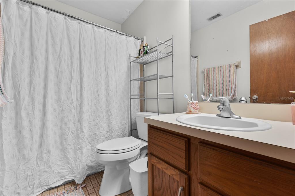 900 Southwest 62nd Boulevard, Unit L79 Gainesville, FL 32607 - Photo 9 of 24 a bathroom with a sink a toilet and shower