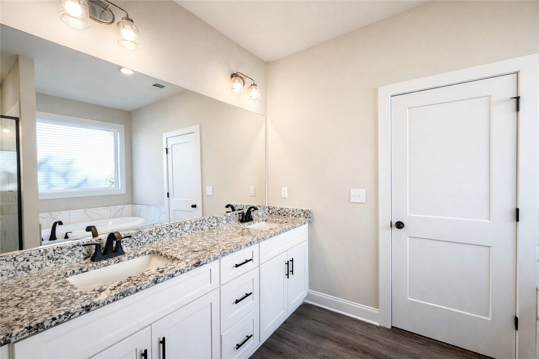 106 Player Lane Westminster, SC 29693 - Photo 12 of 24 This spacious bathroom offers a double vanity with ample counter space and a pristine soaking tub.