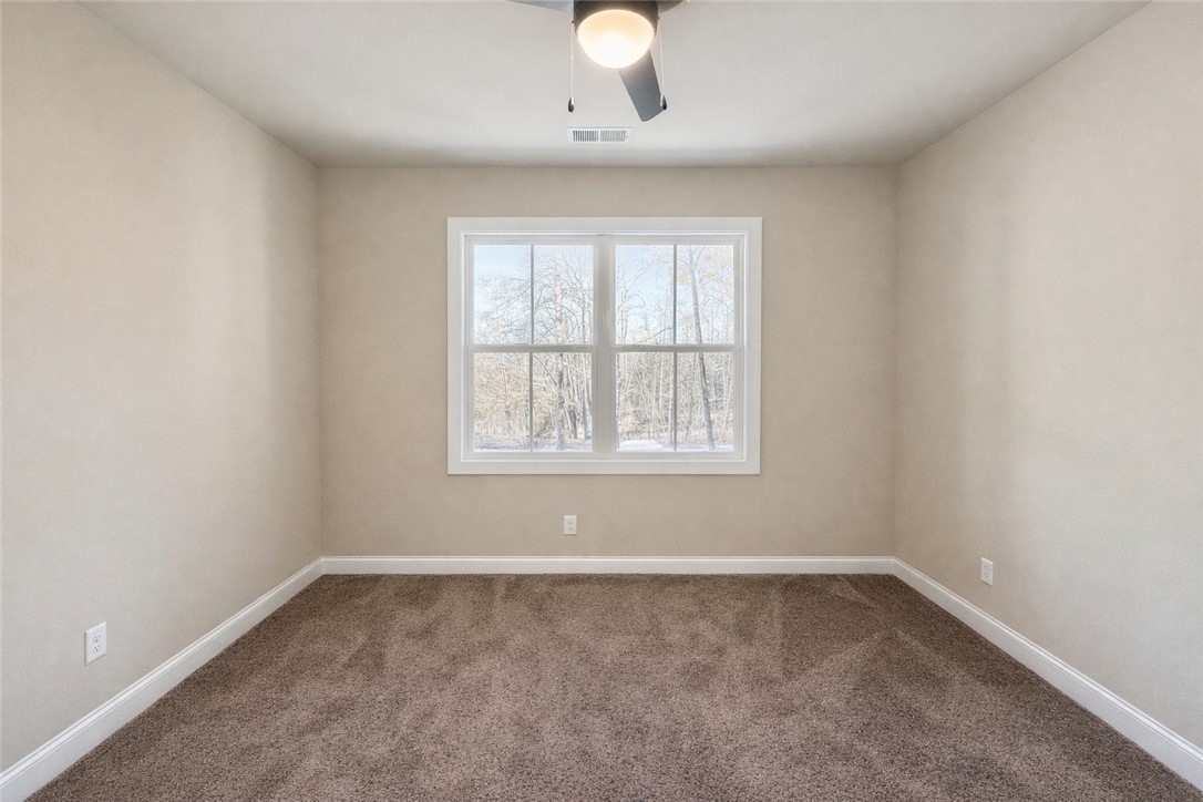 106 Player Lane Westminster, SC 29693 - Photo 16 of 24 This cozy bedroom features plush carpeting and a bright window, offering a serene escape.
