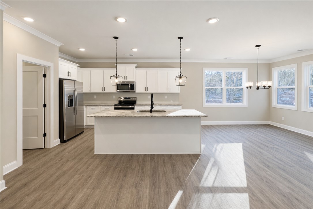 106 Player Lane Westminster, SC 29693 - Photo 5 of 24 This bright, open-concept kitchen features modern appliances and a central island, perfect for gathering.
