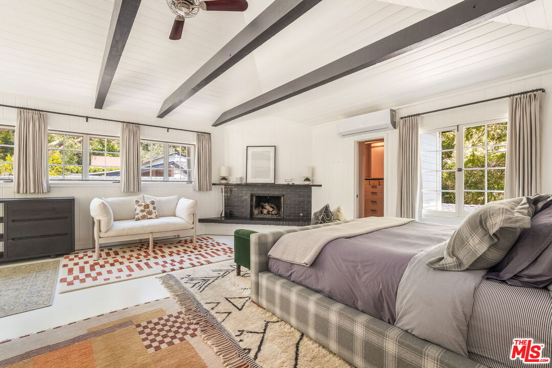 2015 Nichols Canyon Road Los Angeles, CA 90046 - Photo 12 of 27 a bedroom with a large bed couch and windows