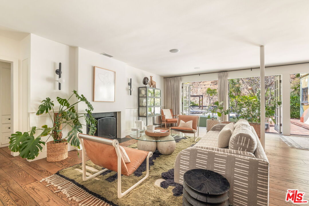 2015 Nichols Canyon Road Los Angeles, CA 90046 - Photo 2 of 27 a living room with fireplace furniture and a large window
