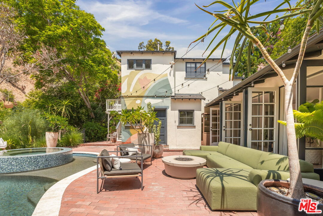 2015 Nichols Canyon Road Los Angeles, CA 90046 - Photo 24 of 27 a view of a patio with couches table and chairs and potted plants