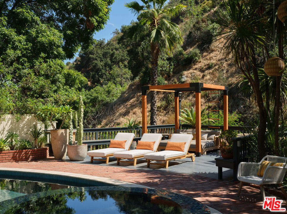 2015 Nichols Canyon Road Los Angeles, CA 90046 - Photo 26 of 27 a view of a patio with table and chairs potted plants and large tree