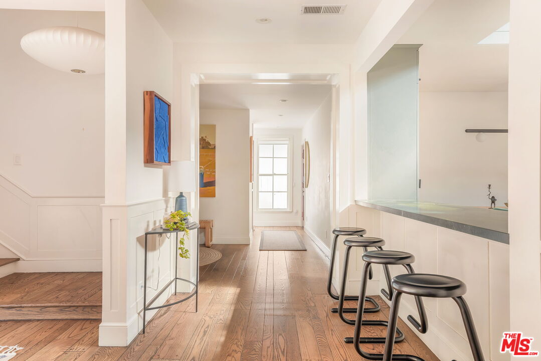 2015 Nichols Canyon Road Los Angeles, CA 90046 - Photo 4 of 27 a view of a dining room with furniture and wooden floor