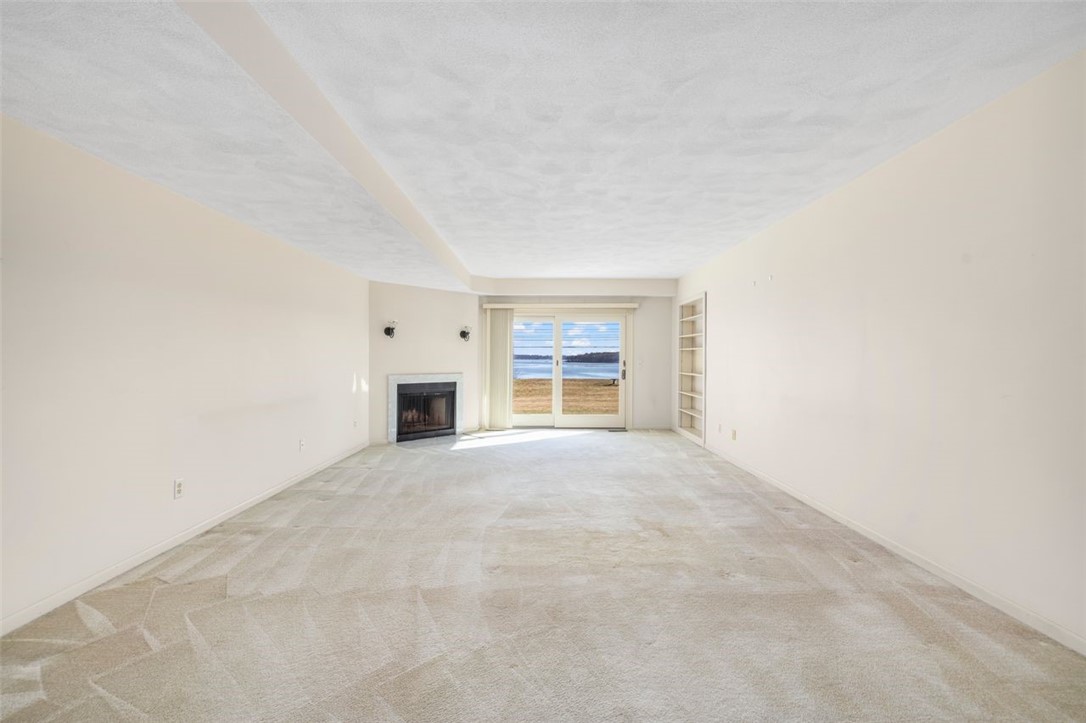 4496 Post Road, Unit 3 Warwick, RI 02818 - Photo 4 of 44 Ample Size Living room with wood burning fireplace & water view