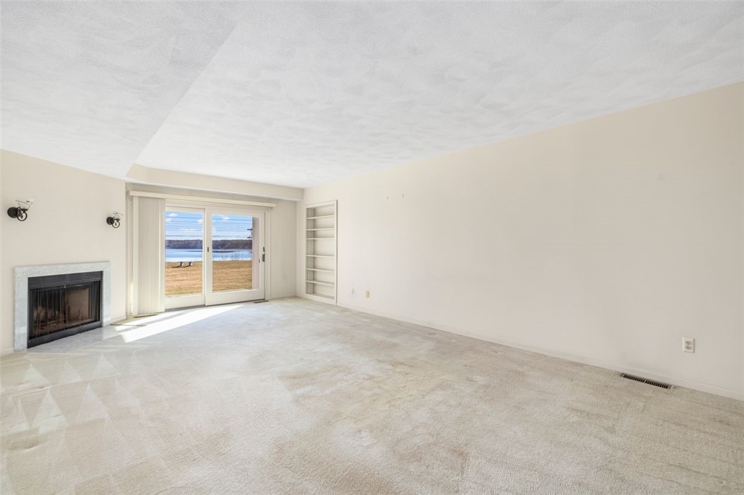 4496 Post Road, Unit 3 Warwick, RI 02818 - Photo 5 of 44 Living room with water view & fireplace.