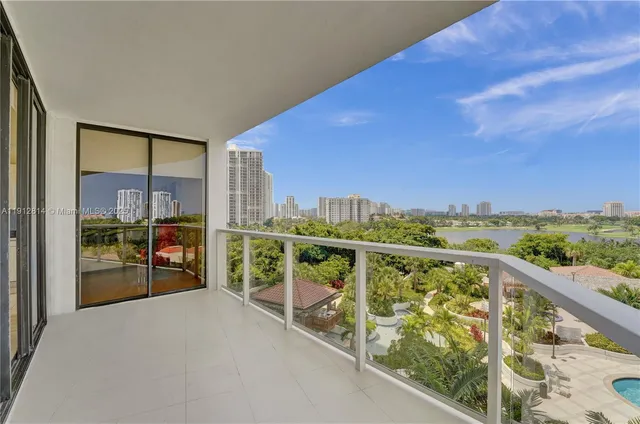 a dining room with furniture a chandelier and wooden floor