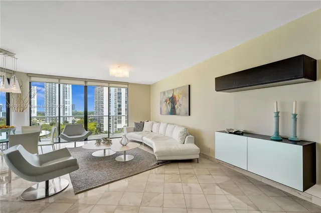 a bedroom with two beds and a large window