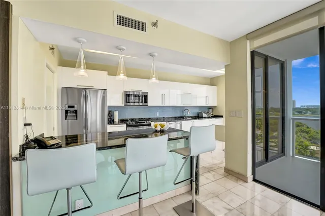 a bedroom with a bed couch and a large window