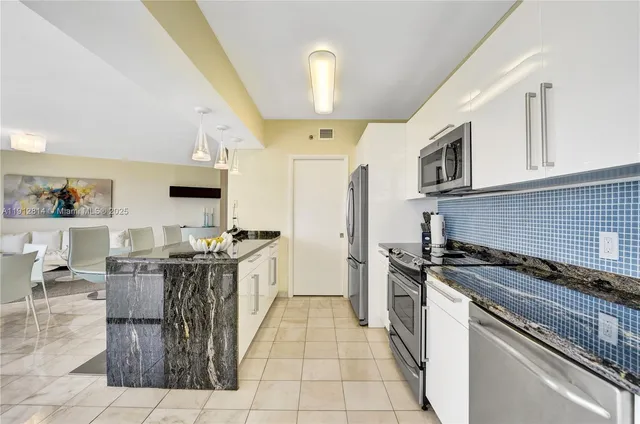a view of a swimming pool with a bench and trees in the background
