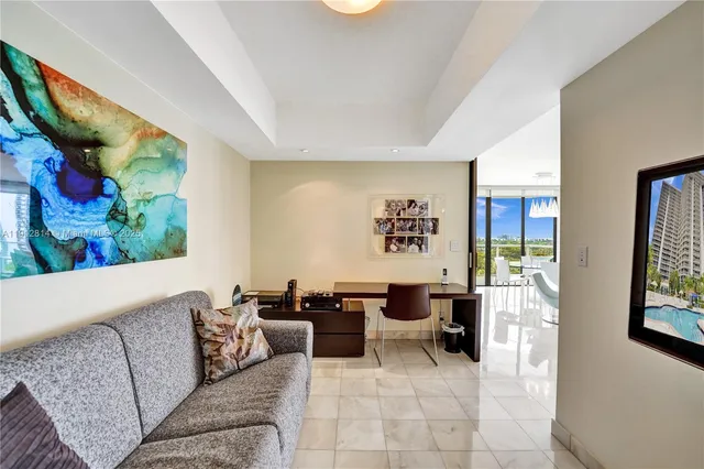 a patio with table and chairs and potted plants