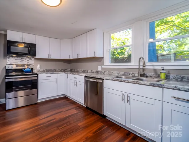 a kitchen with stainless steel appliances a stove and a refrigerator
