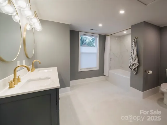a spacious bathroom with a double vanity sink mirror and double